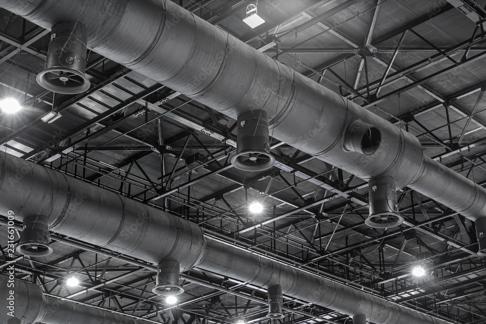 Foto Stock HVAC Duct Cleaning, Ventilation pipes in silver insulation  material hanging from the ceiling inside new building. | Adobe Stock