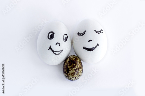 Funny eggs imitating a happy smiling family with baby