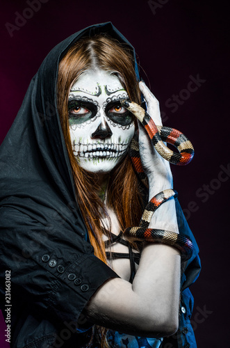 Beautiful halloween portrait and king snake. Dead face.