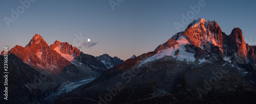 Fototapeta Naklejka Na Ścianę i Meble -  Panorama of the last sunlight on the mountain peaks near Chamonix, France, during moonrise.
