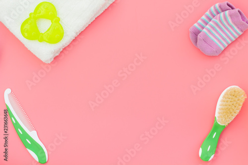 Hygiene items for the child. Bath accessories on pink background top view copy space frame