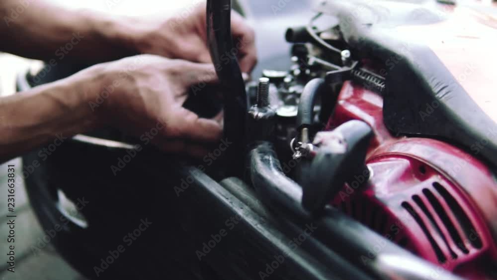 dirty working hands in karting repair garage, repairing parts, Street kartings, fun concept, place for text, championship, slow motion dirty working hands in karting repair garage, repairing parts, Street kartings, fun concept, place for text, championship, slow motion