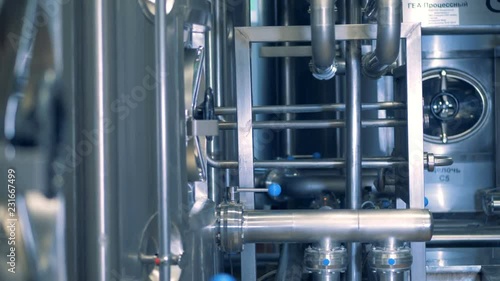 Brewery interior with lots of pipes and storages.