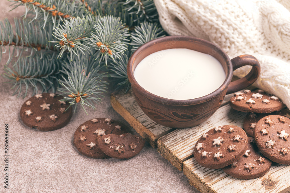 Chocolate cookies with jar of hot milk on the old wooden cutting board. Chocolate cookies with jar of hot milk on the old wooden cutting board.