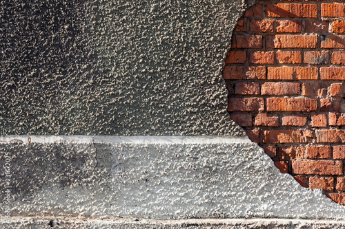 Destroyed building, red brick, gray concrete. Concept textural background, abandoned house, factory photo