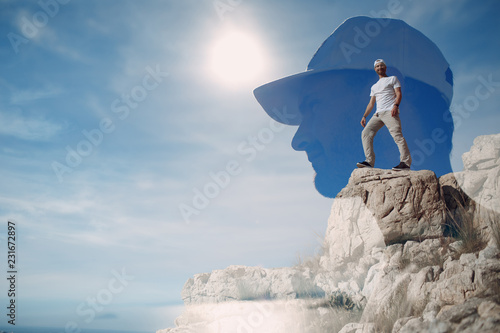 Young male rock climber on a cliff top