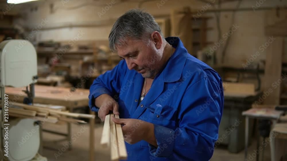 Carpenter at work in his Studio, man makes measurements Carpenter at work in his Studio, man makes measurements
