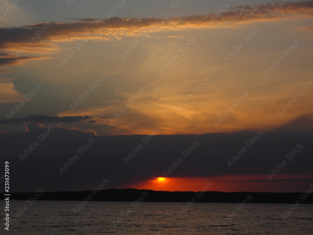 Sunset. On the big river. Coast. Beautiful clouds. Summer. Russia, Ural, Perm region