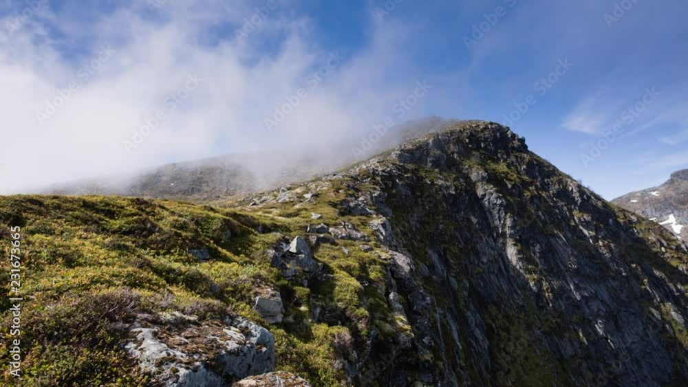 Clouds pass over the Merraflestinden mountaintop on the Lofoten islands, Norway. Clouds pass over the Merraflestinden mountaintop on the Lofoten islands, Norway.