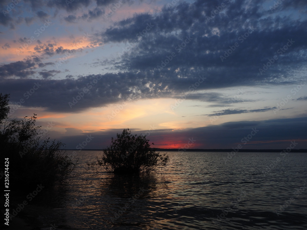 Sunset. On the big river. Beautiful sky. Tree and leaves. Summer. Russia, Ural, Perm region