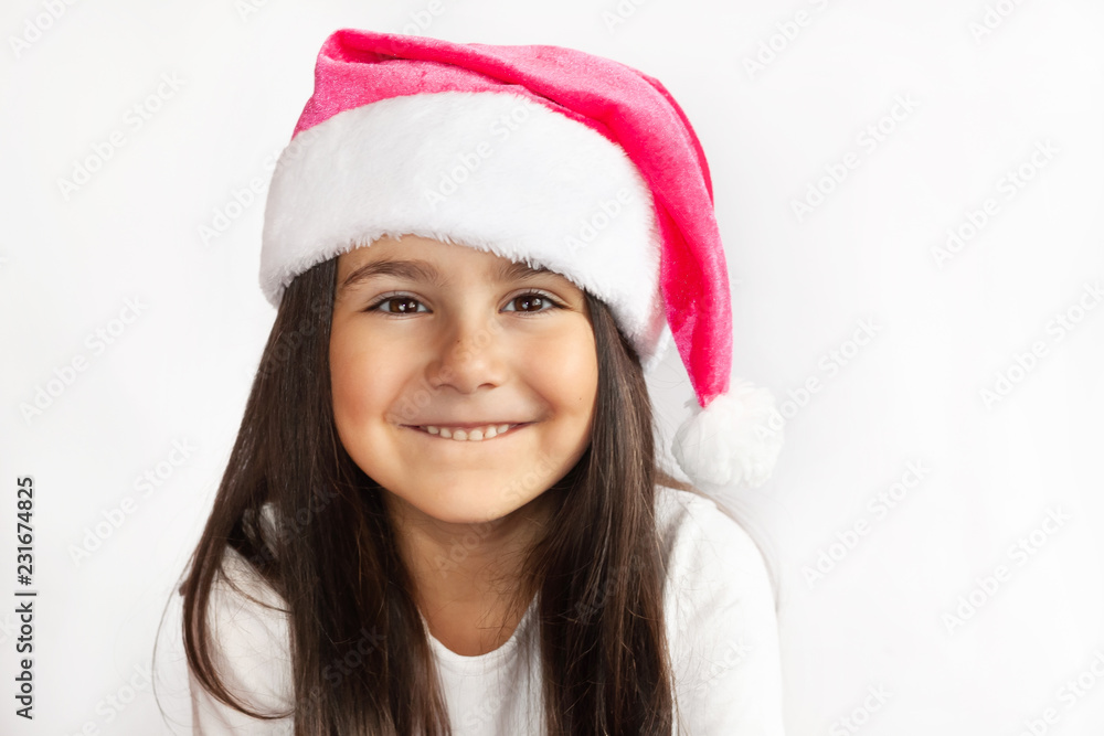 Christmas time - happy child girl with Santa Claus Hat Christmas time - happy child girl with Santa Claus Hat