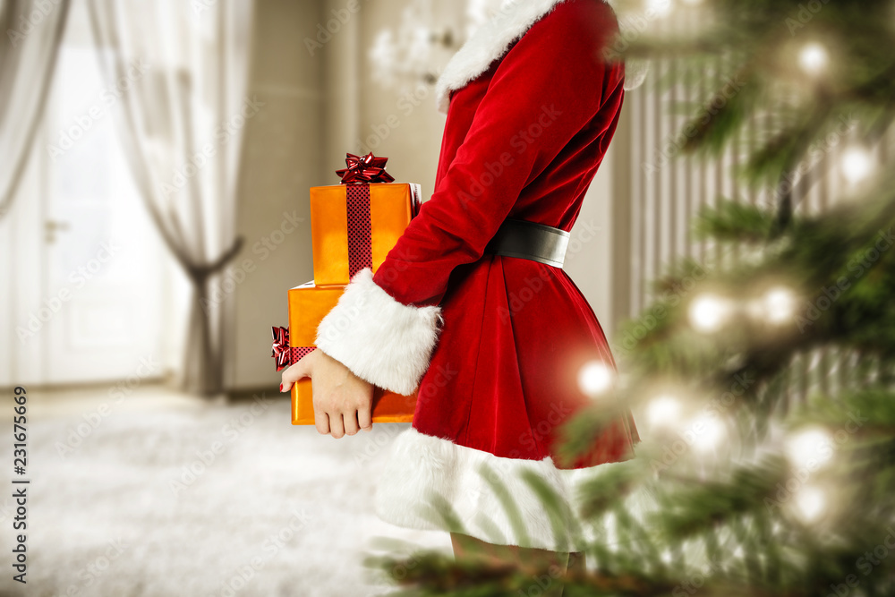 Christmas time and Santa Claus woman with gifts 