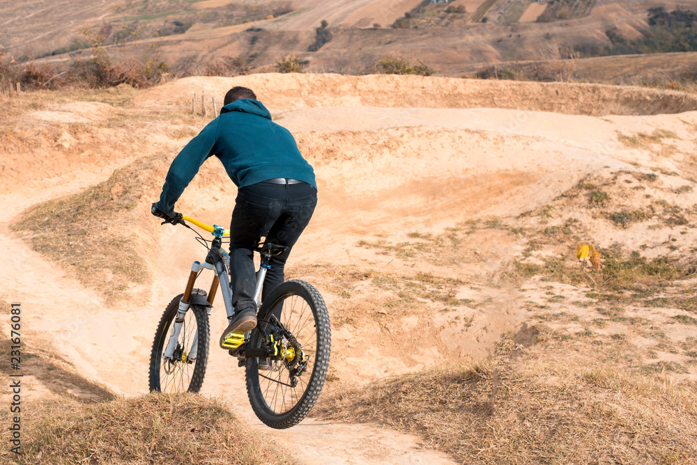 Man riding mountain bike on a mountain bike track Man riding mountain bike on a mountain bike track