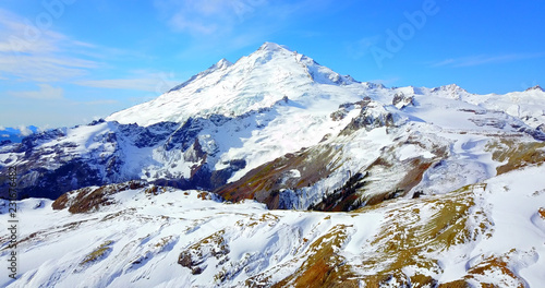 Aerial Overhead View Of Snowy Rocky Peak On Mount Baker, Washington, USA photo