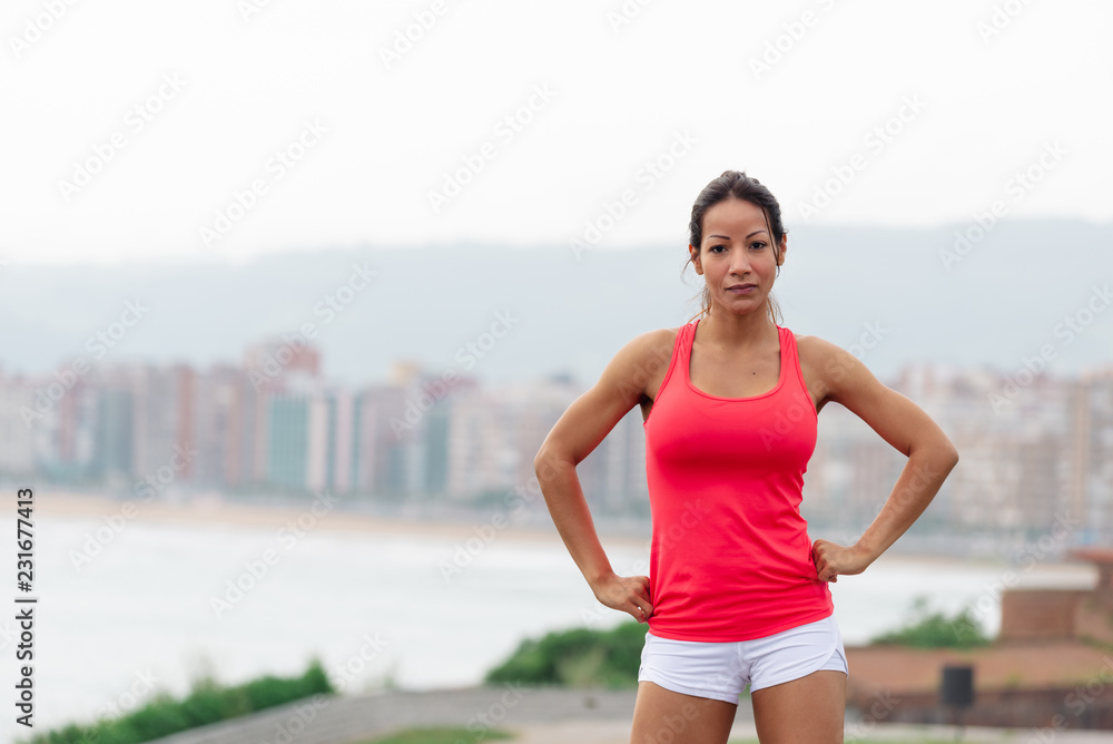 Successful sporty woman towards city scape