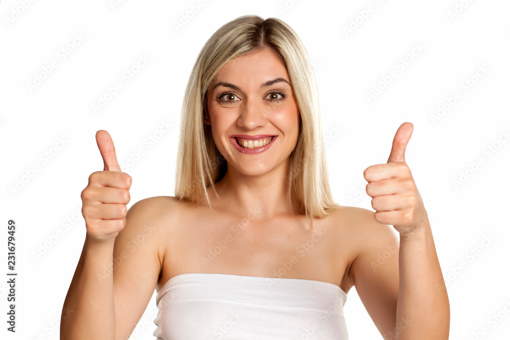 Portrait of young beautiful woman on white backgeound showing thumbs up Portrait of young beautiful woman on white backgeound showing thumbs up