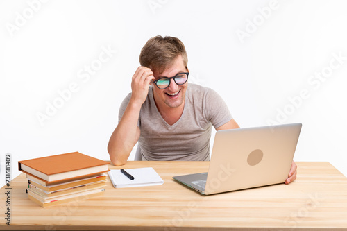 Study, education, people concept - man doing exercises in netbook, looking amazed