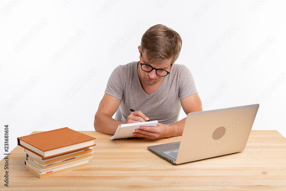 Study, education and people concept - man nerd doing exercises near the laptop Study, education and people concept - man nerd doing exercises near the laptop