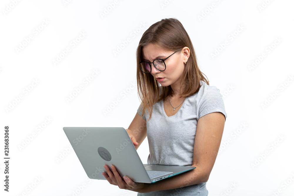 People and education concept - Attractive student woman holding a laptop over white background People and education concept - Attractive student woman holding a laptop over white background