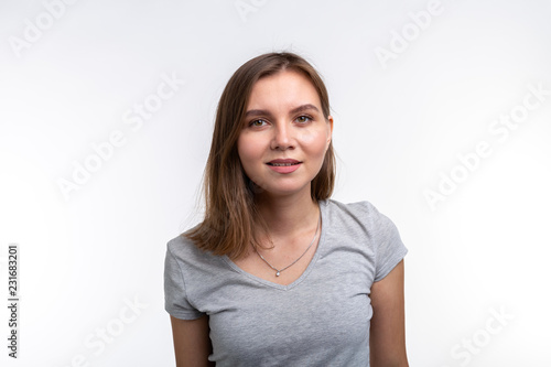People and education concept - Close up portrait of lovely girl in grey shirt over white background