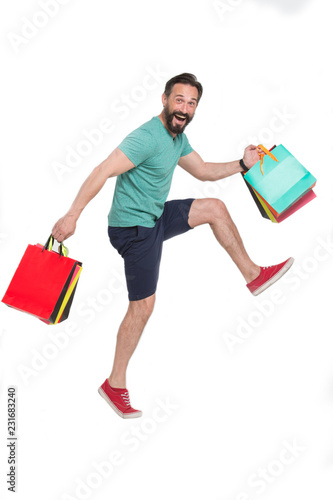 Funny man putting his knee high while running with paper bags