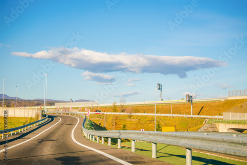 Landscape view on Expressway with mountains and blue sky background.