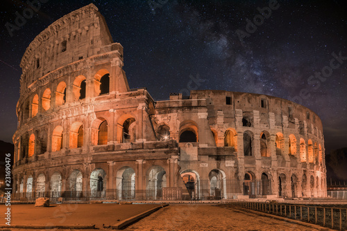 Vászonkép Coliseum in Rome by Night with milky way-  Colosseum is one of the main travel a