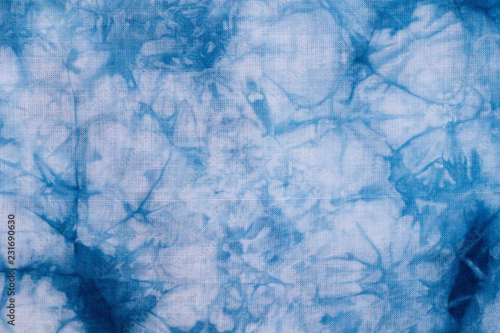 Fototapeta premium Pattern of blue dye on cotton cloth, Dyed indigo fabric background and textured