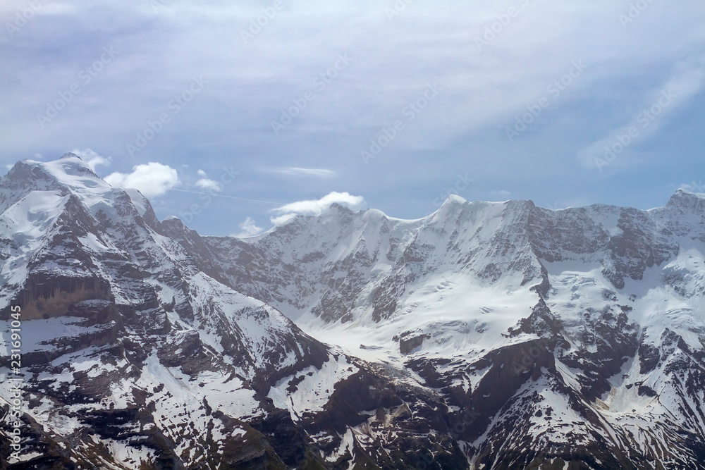 View of the Bernese Alps from the top of Schilthorn on a summer day. Alpine mountains.