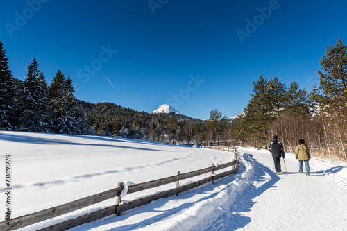 couple hiking in Seefeld in Tyrol on a sunny winter day
