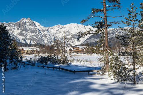 Seefeld lake in Tyrol on a sunny winter day with view to the village
