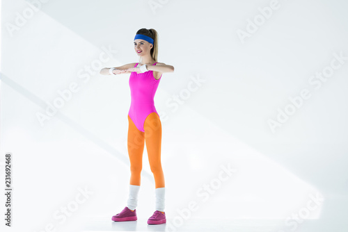 sporty young woman training at aerobics workout on grey