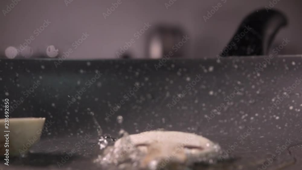 Sliced mushroom being dropped into a frying pan in slow motion, 480 fps Sliced mushroom being dropped into a frying pan in slow motion, 480 fps