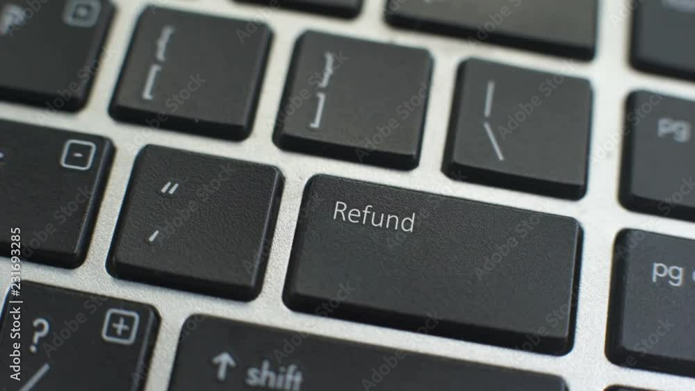 Refund button on computer keyboard, female hand fingers press key Refund button on computer keyboard, female hand fingers press key