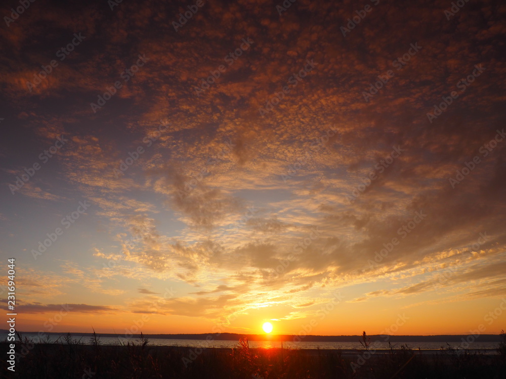 Fototapeta premium Sunset. On the big river. Coast. Beautiful clouds. Summer. Russia, Ural, Perm region
