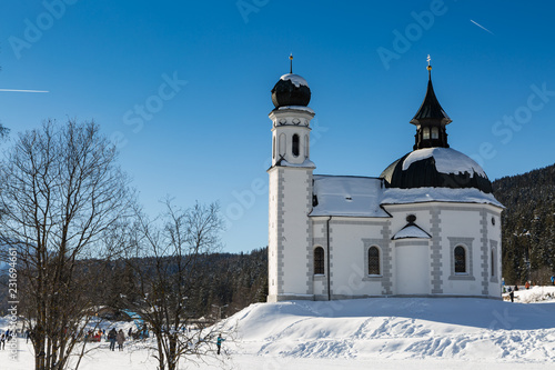 landmark Seekirchl church in Seefeld covered in snow on sunny winter day © nobelbunt