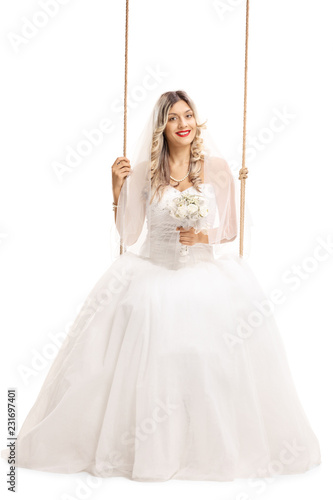 Smiling bride sitting on a swing