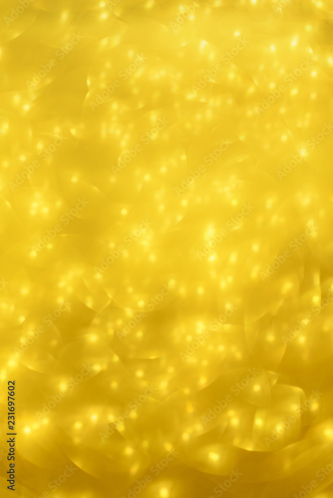 Golden shiny background, copy space for your Christmas greetings. Banner with defocused lights, bright yellow bokeh. Shimmer of gold glitter texture. Concept of New year, luxury holiday. Golden shiny background, copy space for your Christmas greetings. Banner with defocused lights, bright yellow bokeh. Shimmer of gold glitter texture. Concept of New year, luxury holiday.