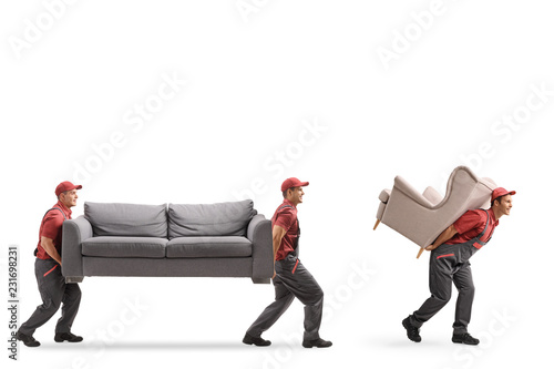 Movers carrying a couch and an armchair
