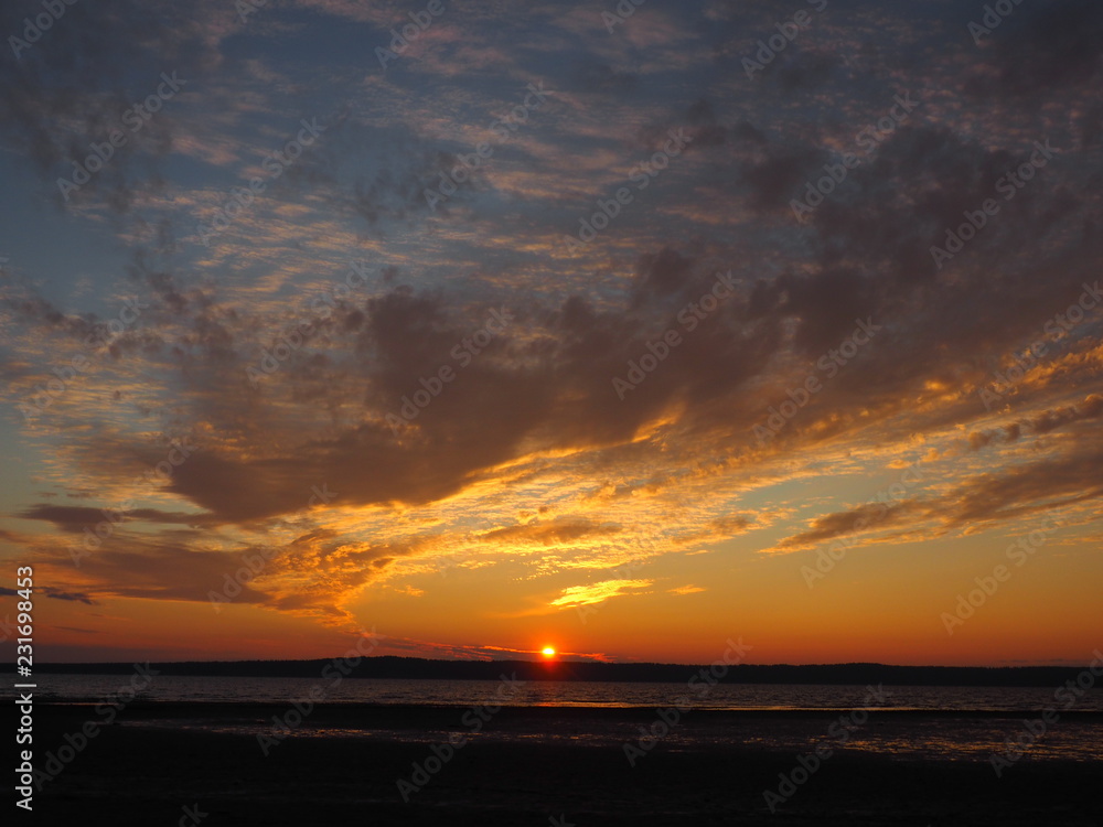 Naklejka premium Sunset. On the big river. Coast. Beautiful clouds. Summer. Russia, Ural, Perm region
