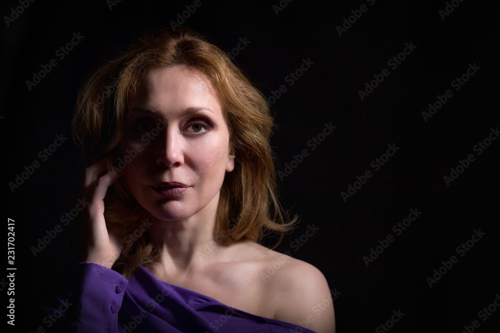 Middle aged woman portrait on black background
