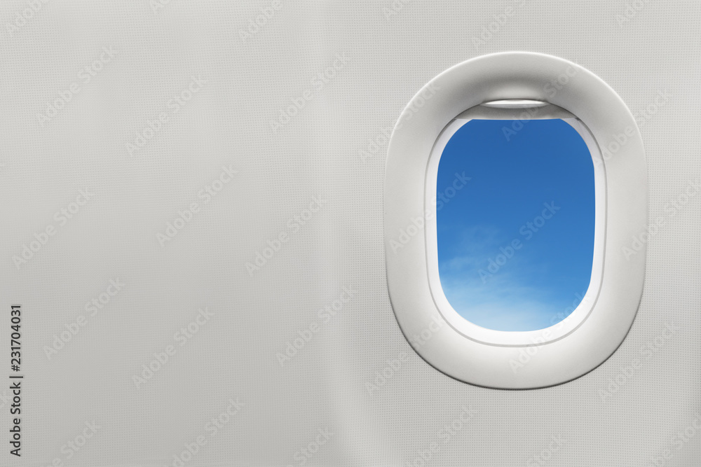 Isolated airplane window with blue sky Isolated airplane window with blue sky