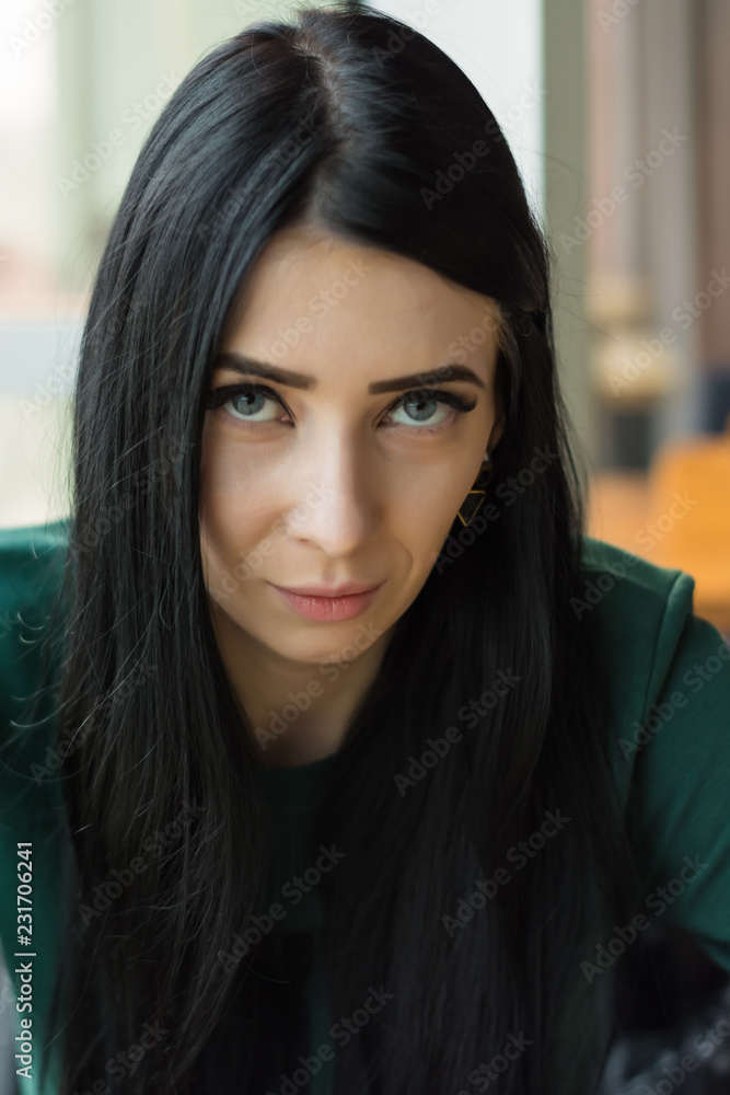dark-haired young woman with a sly, provocative, flirting look dark-haired young woman with a sly, provocative, flirting look