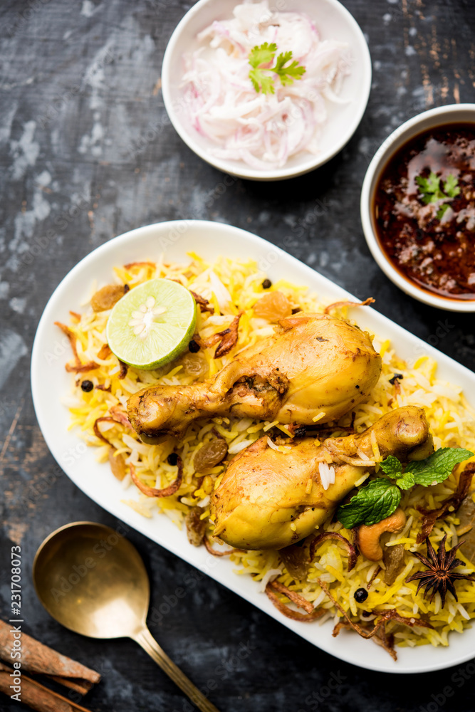 Delicious spicy chicken biryani in bowl over moody background, it’s a popular Indian and Pakistani food. Delicious spicy chicken biryani in bowl over moody background, it’s a popular Indian and Pakistani food.
