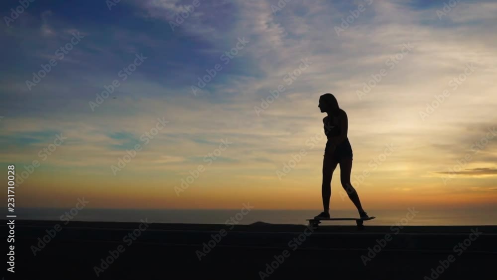 Silhouette of a skateboarder against the sunset sky in slow motion steadicam shot Silhouette of a skateboarder against the sunset sky in slow motion steadicam shot