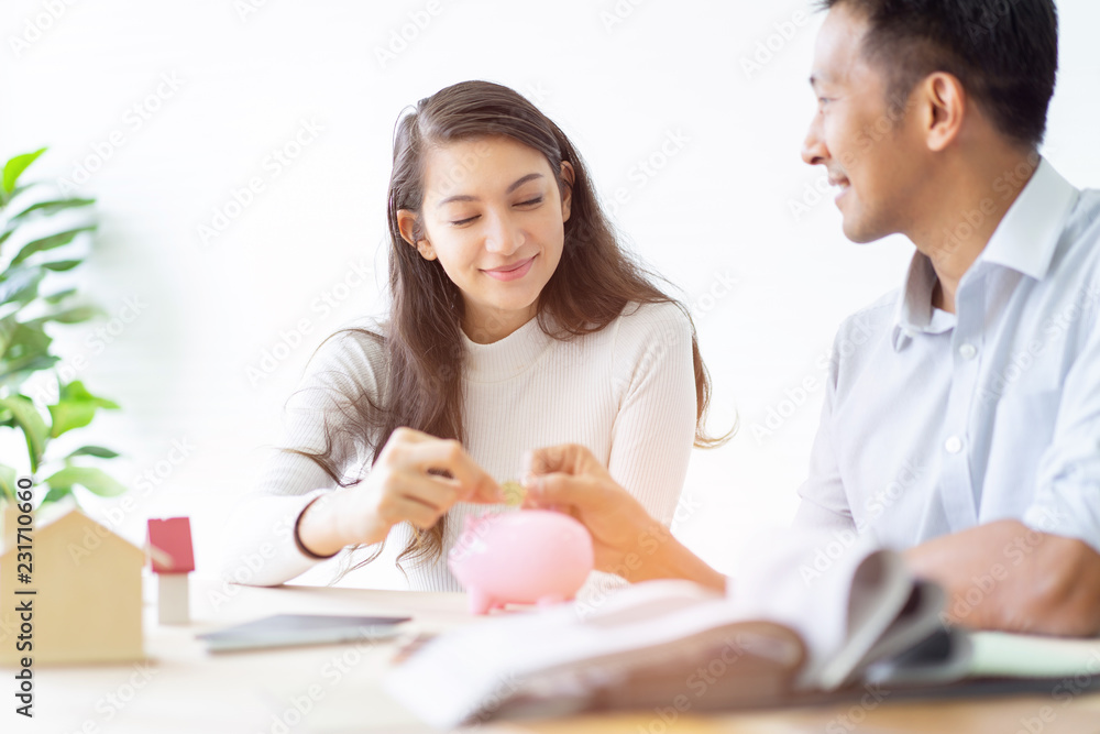 Happy couple plan buying house.Concept for Couple saving money for buy home and real estate. Select material for decorate furniture. Happy couple plan buying house.Concept for Couple saving money for buy home and real estate. Select material for decorate furniture.