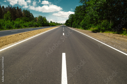 Asphalt car road and clouds