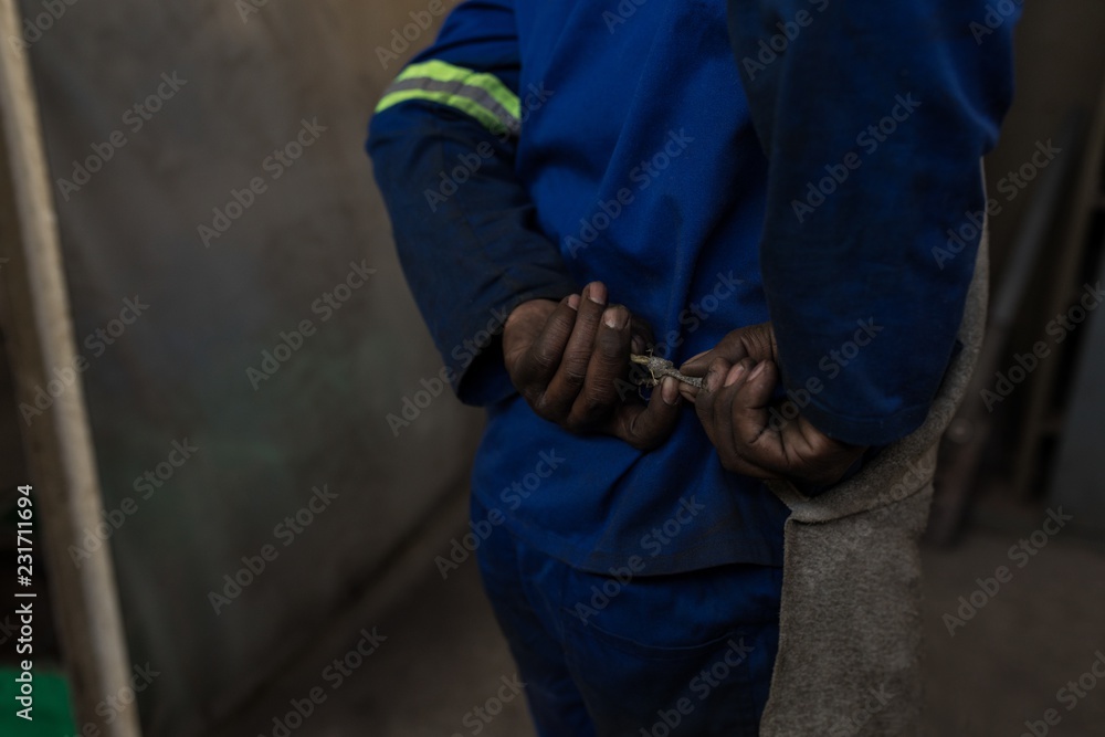 Blacksmith holding tool in workshop Blacksmith holding tool in workshop