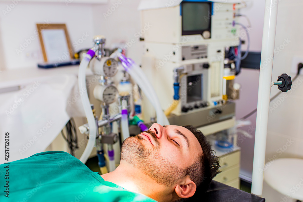Fototapeta premium Young man lies on the operating table
