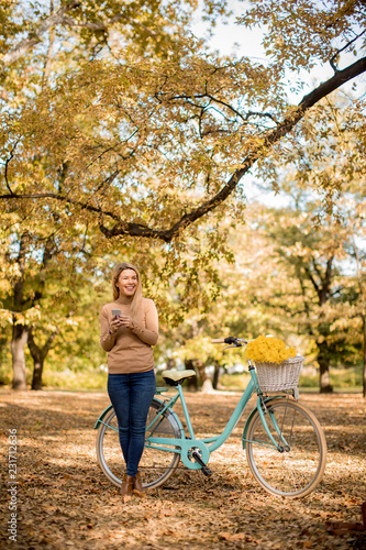 Young woman with bicycle us...